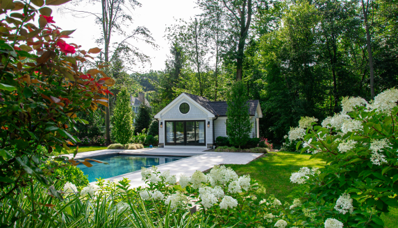 floral garden and landscape surrounding pool and patio and cabana