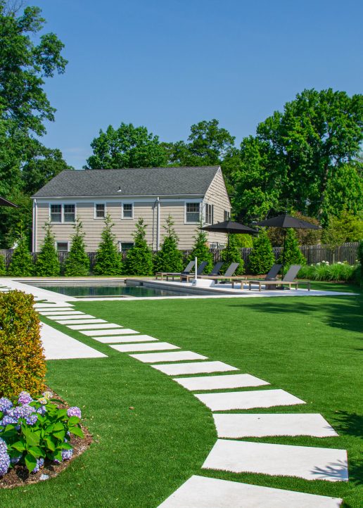 Welcoming stone pathway leading into the spacious backyard area.