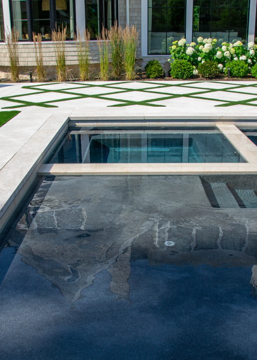 Custom patio and spa design for this modern pool. 
